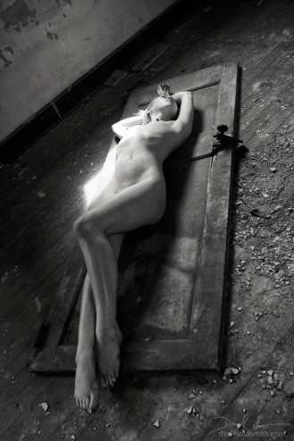 foris - Isis laying nude on a broken door by the Photosmith